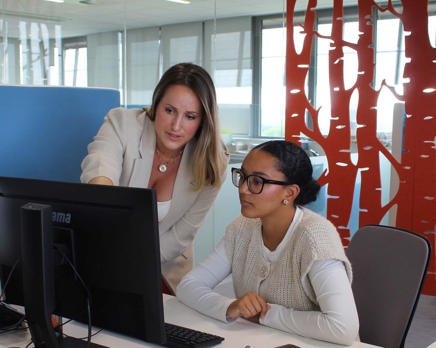 Deux jeunes collaboratrice de Digitatel observant les résultats sur un ordinateur